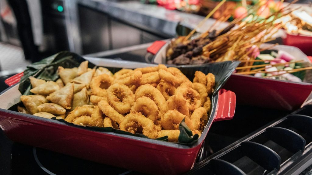 delicious fried calamari and samosas in red dish