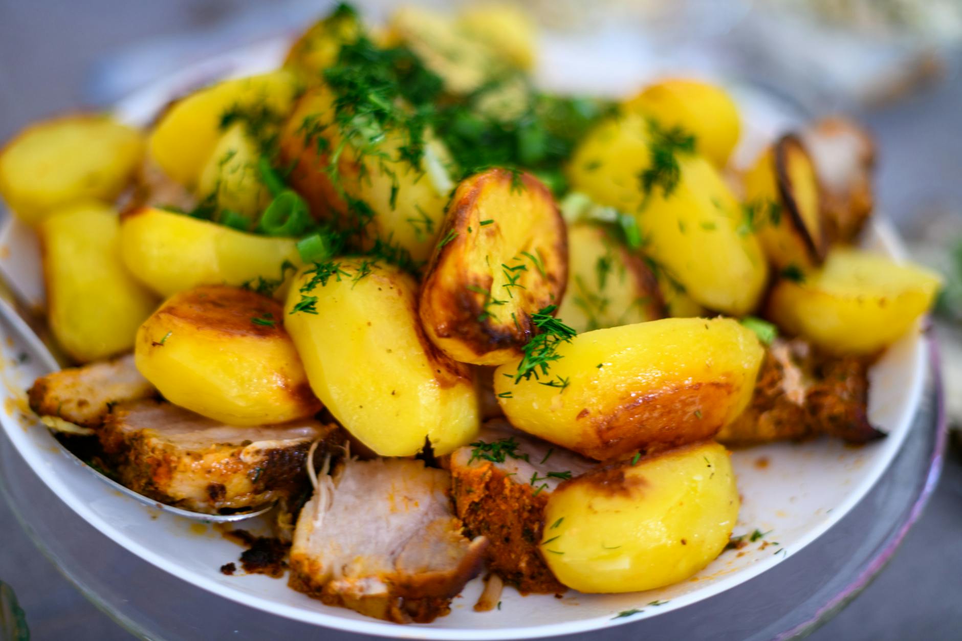 roasted potatoes and meat with fresh dill