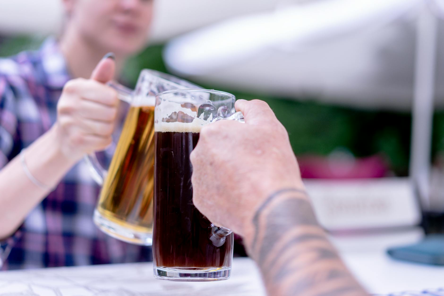 people clinking of beer glasses