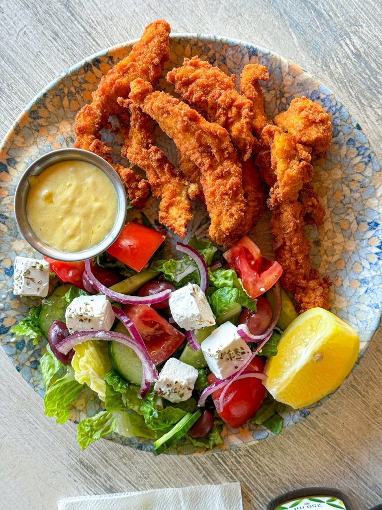 a plate with chicken salad and dressing