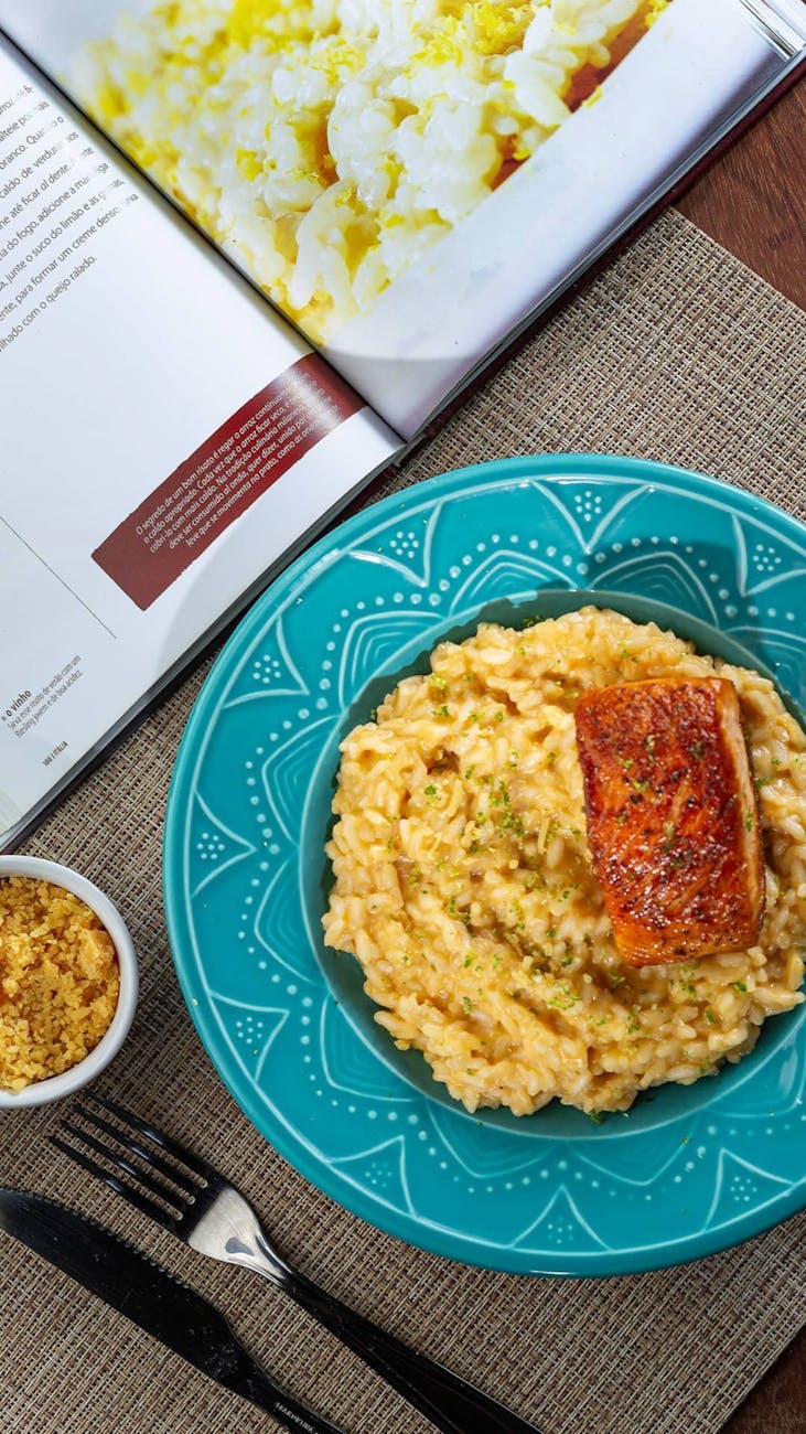 homemade carbonara on table witk cookbook