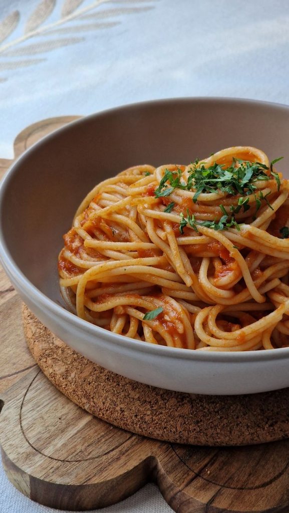 delicious spaghetti with tomato sauce and herbs