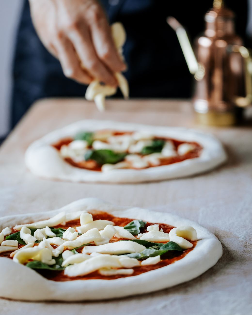 close up of man preparing pizza