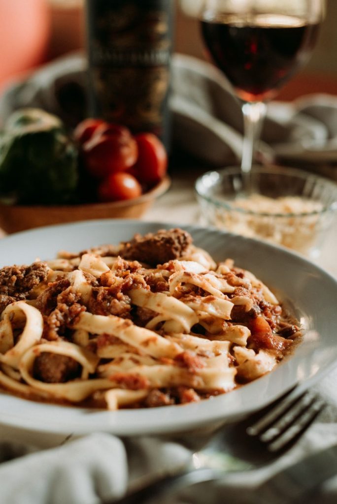 pasta with meat in plate on table