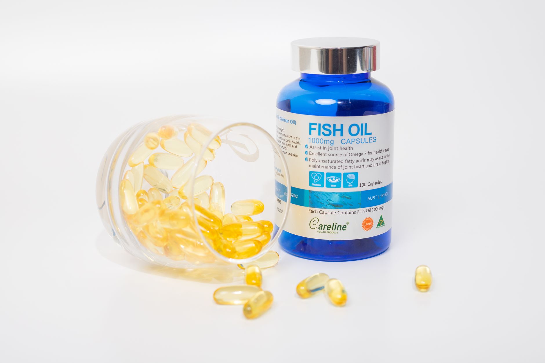 fish oil capsules and bottle on white background