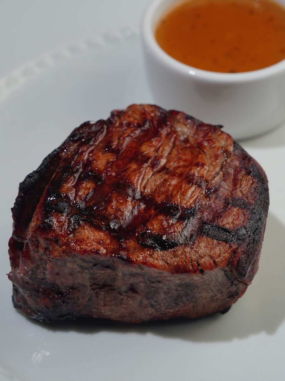 juicy grilled filet mignon on white plate
