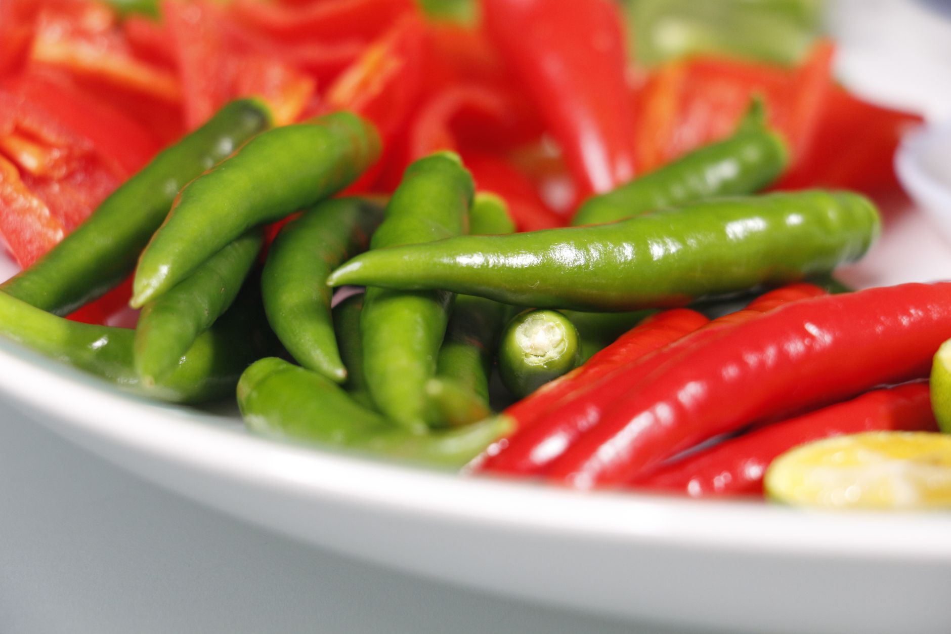a close up shot of red and green chili peppers