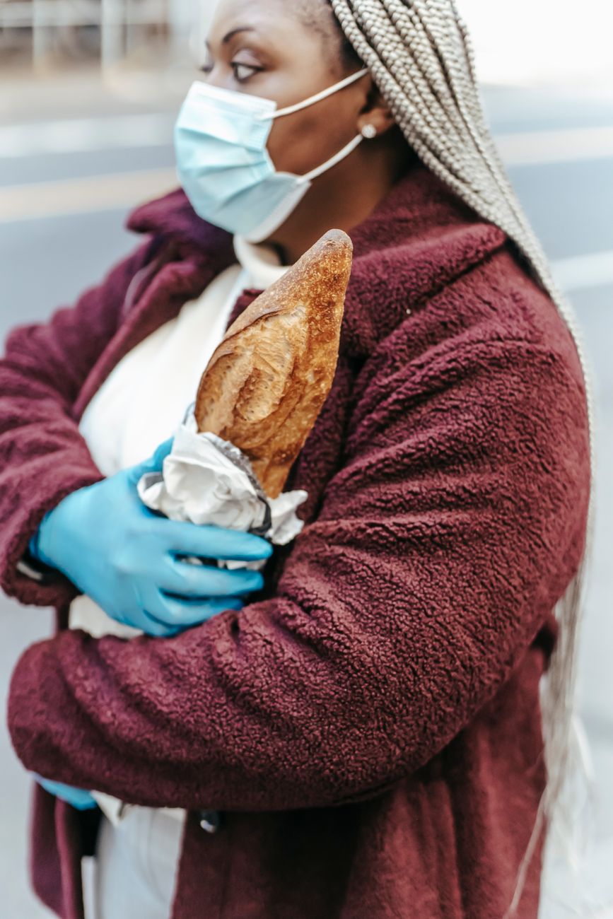 faceless african american woman in mask and gloves in street