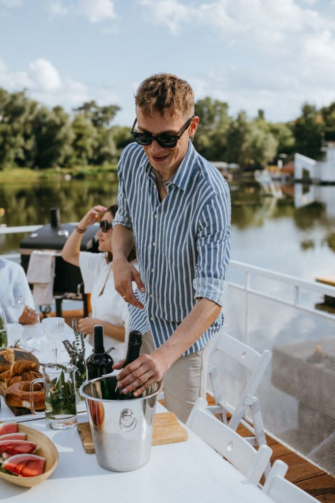 a man taking a champagne bottle from an ice bucket