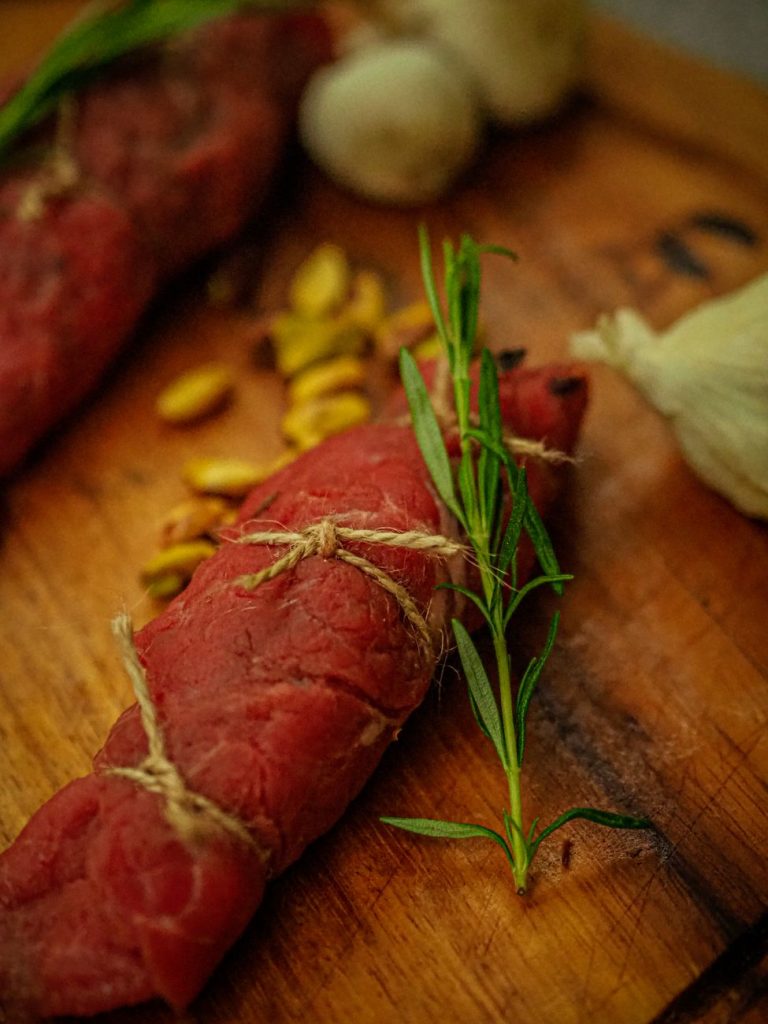 red meat on a wooden chopping board