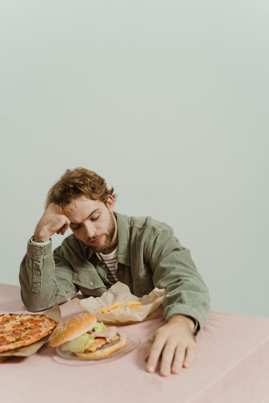 bored man looking at the foods in the table