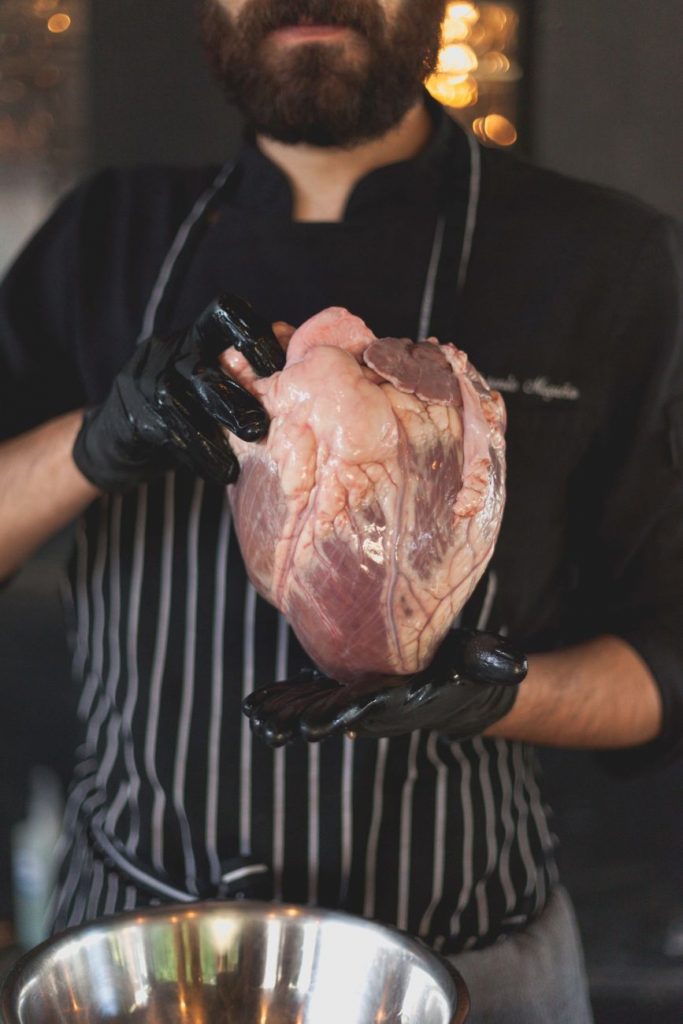 man holding raw meat
